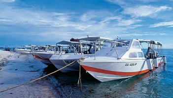 Dive boats moored beside a beach