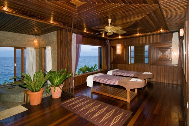Massage room with two beds and a sea view at the Ka'andaman Spa