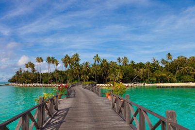 Wooden jetty leading to palm-fringed Mabul Island