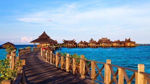 Wooden walkway leading to the over-water bungalows of Mabul Water Bungalows