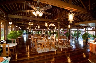 Open-air restaurant with timber floor and ceiling fans at Mabul Water Bungalows